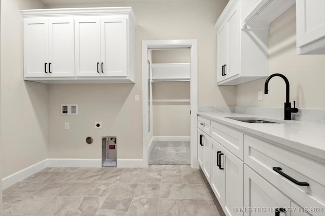 clothes washing area with washer hookup, cabinets, hookup for an electric dryer, and sink