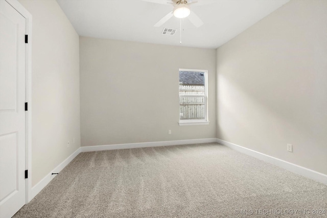 carpeted spare room with ceiling fan