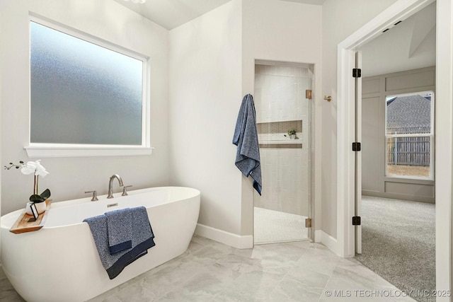 bathroom with plenty of natural light and shower with separate bathtub