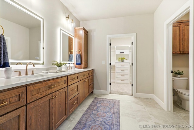 bathroom featuring toilet and vanity