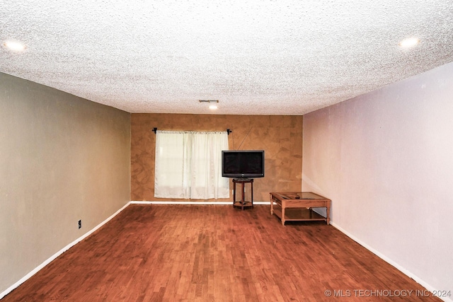 interior space featuring dark hardwood / wood-style flooring and a textured ceiling