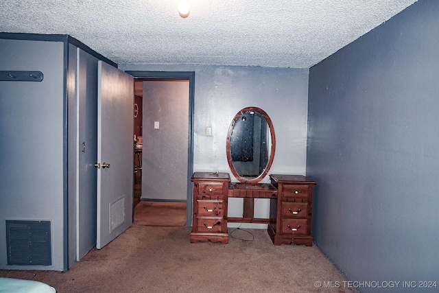 carpeted bedroom with a textured ceiling