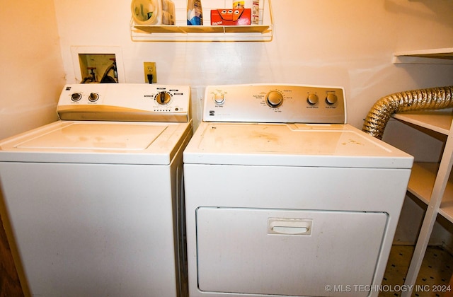 clothes washing area featuring independent washer and dryer