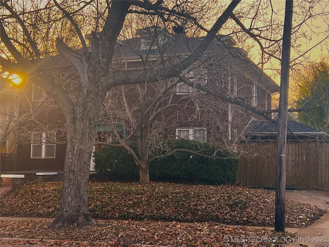 view of side of property featuring fence