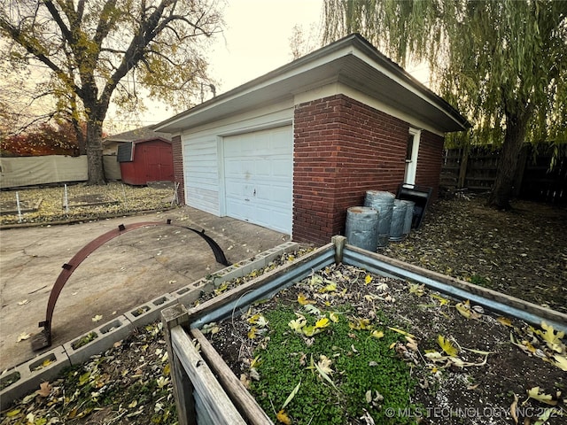 exterior space with a garden, fence, and driveway