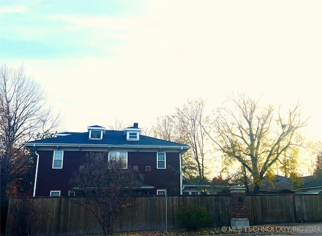 rear view of property featuring fence