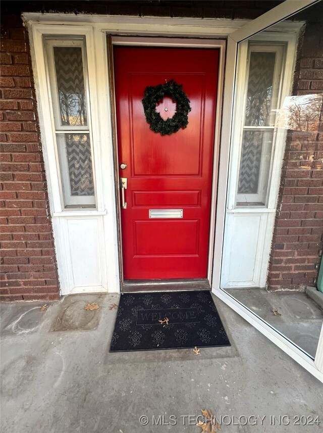 view of exterior entry with brick siding