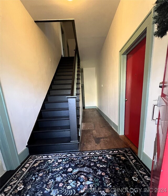 stairs with baseboards and wood finished floors