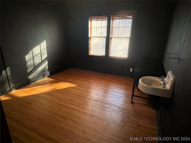 unfurnished room with wood finished floors