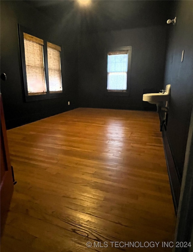 spare room featuring wood finished floors