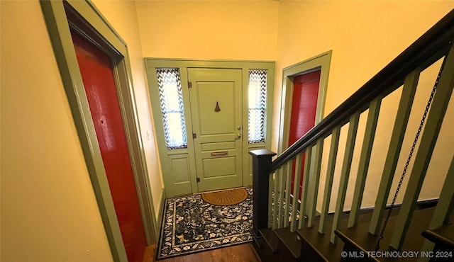 foyer entrance with wood finished floors and stairs