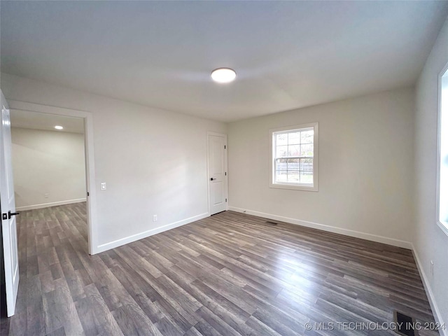 empty room featuring dark hardwood / wood-style flooring