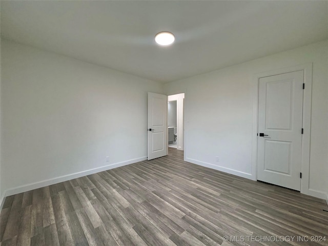 unfurnished bedroom with hardwood / wood-style floors