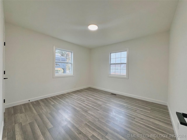 spare room with wood-type flooring