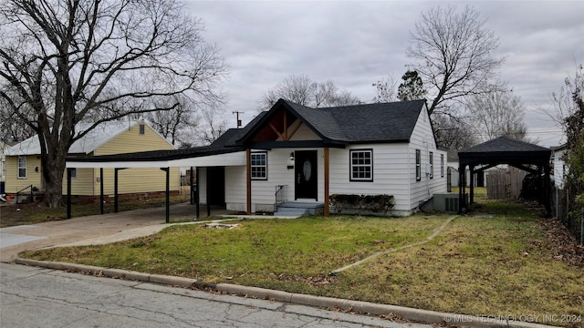 bungalow-style home featuring central AC, a front yard, and a carport