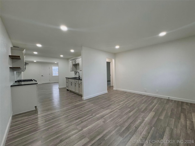 unfurnished living room featuring light hardwood / wood-style floors and sink