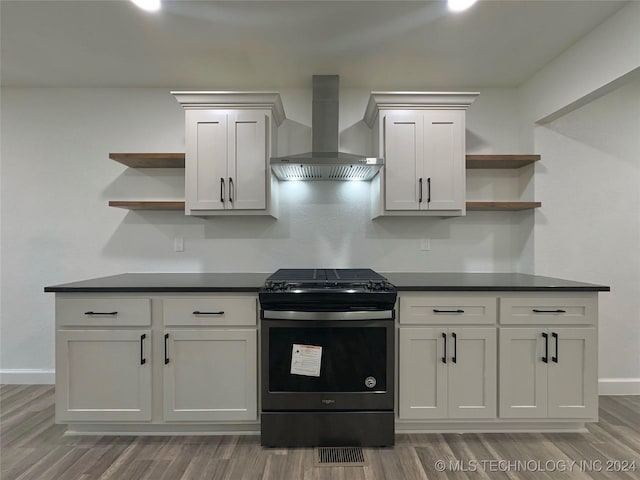 kitchen with stainless steel electric range, dark hardwood / wood-style flooring, and wall chimney range hood