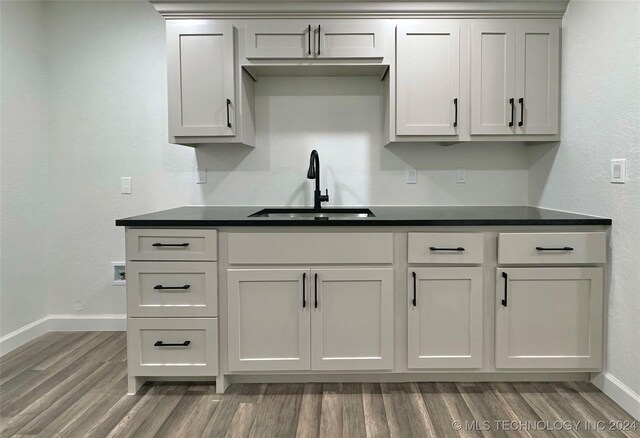 kitchen with hardwood / wood-style floors and sink