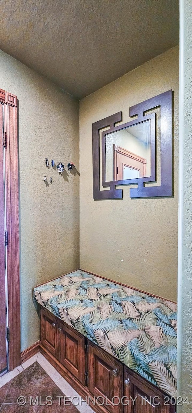 unfurnished bedroom with light tile patterned floors and a textured ceiling