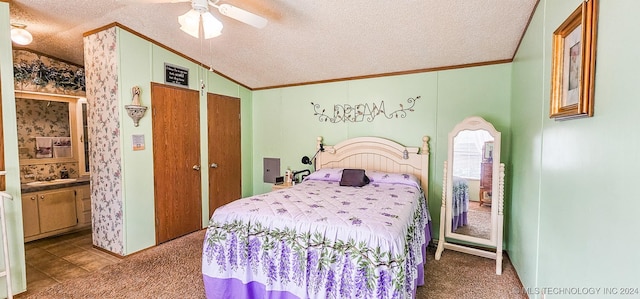 bedroom featuring ceiling fan, carpet floors, a textured ceiling, and vaulted ceiling