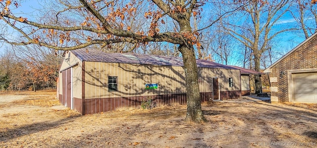 view of property exterior featuring an outbuilding and a garage