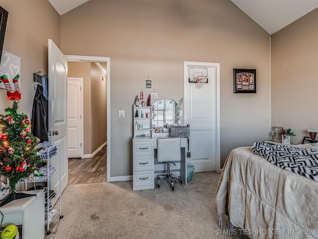 carpeted bedroom with vaulted ceiling