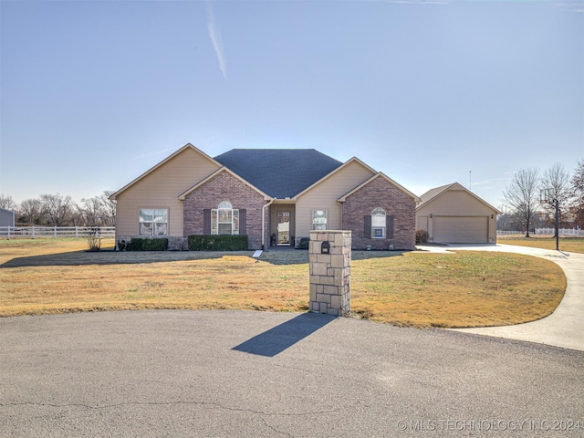 view of front of property featuring a garage and a front lawn