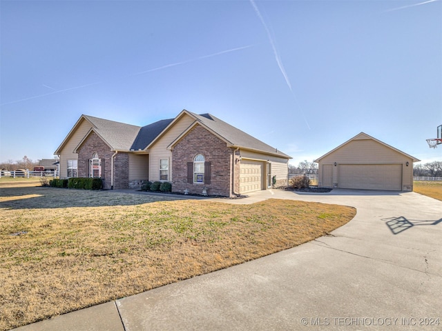 view of front of property featuring a front yard and a garage