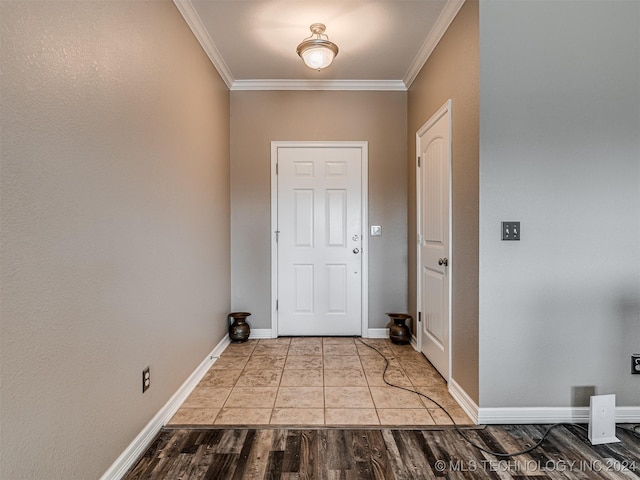 entryway featuring light hardwood / wood-style floors and ornamental molding