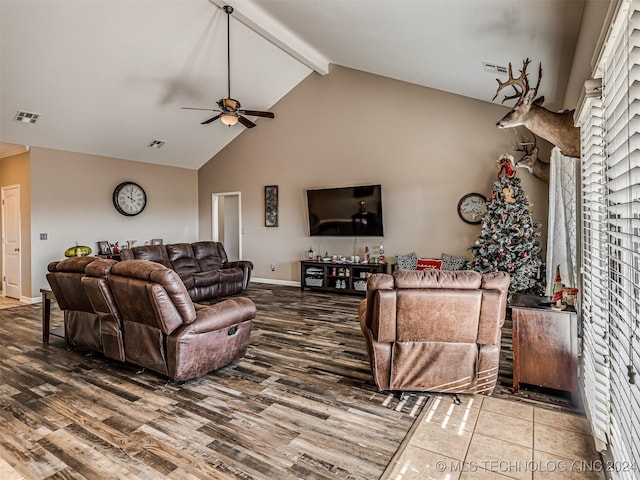 living room featuring hardwood / wood-style flooring, ceiling fan, beamed ceiling, and high vaulted ceiling