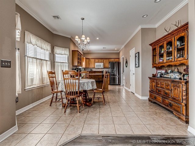 tiled dining space with a notable chandelier and ornamental molding