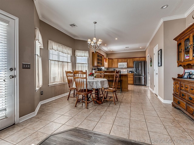 tiled dining space featuring a notable chandelier and crown molding