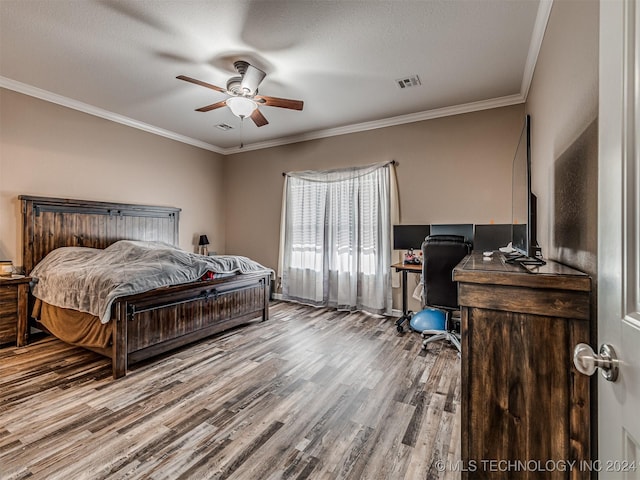 bedroom featuring hardwood / wood-style floors, ceiling fan, ornamental molding, and a textured ceiling