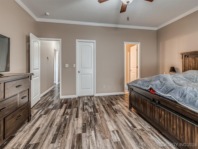 bedroom with dark hardwood / wood-style floors, ceiling fan, and crown molding