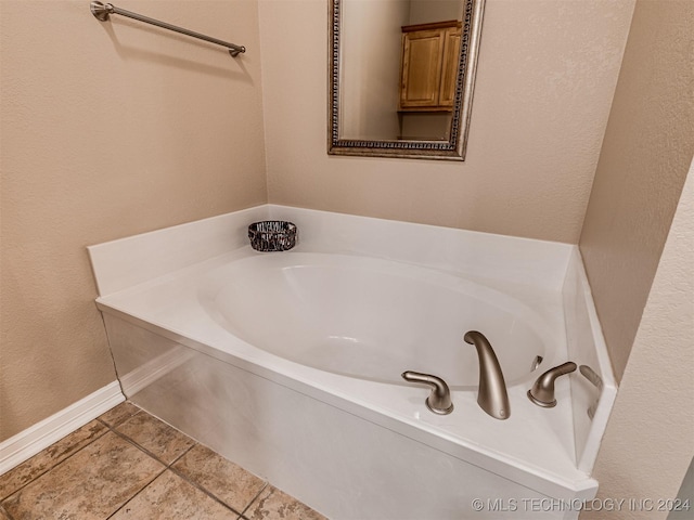 bathroom featuring tile patterned floors and a tub