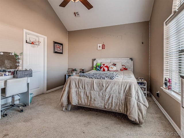 bedroom with ceiling fan, multiple windows, light carpet, and vaulted ceiling