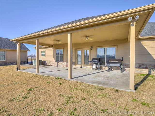 back of house with a yard, cooling unit, ceiling fan, and a patio area