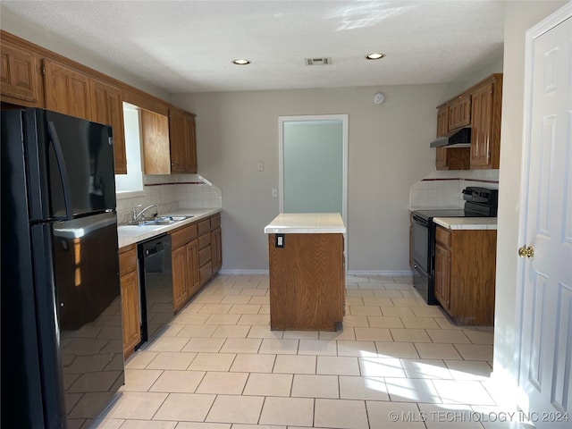 kitchen with light tile patterned floors, sink, backsplash, and black appliances