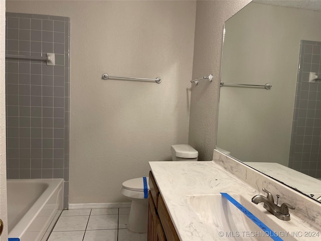 full bathroom featuring tile patterned floors, vanity, toilet, and tiled shower / bath combo