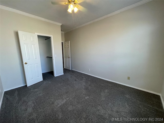 unfurnished bedroom featuring dark carpet, ceiling fan, and ornamental molding