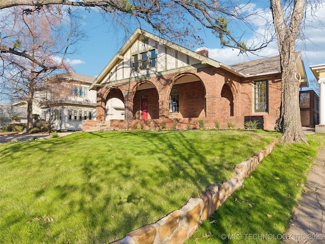 view of front of house with covered porch and a front yard