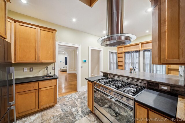 kitchen featuring island exhaust hood and stainless steel range with gas stovetop