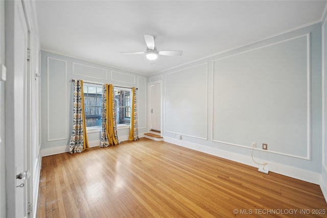 spare room with crown molding, ceiling fan, and light wood-type flooring