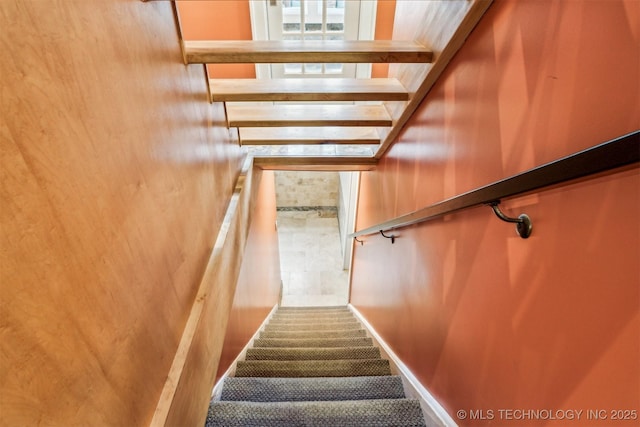 stairs with wood walls