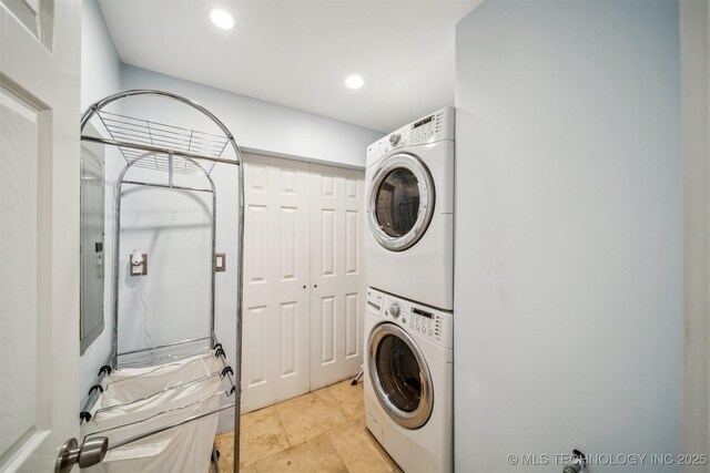 laundry room with stacked washer and dryer