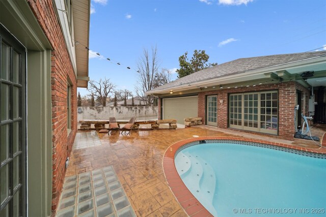 view of swimming pool with a patio