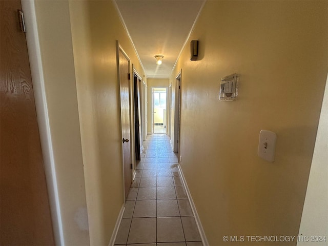 hall with light tile patterned floors