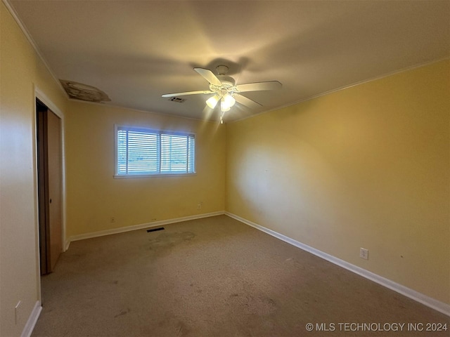 unfurnished bedroom featuring carpet flooring, ceiling fan, and ornamental molding