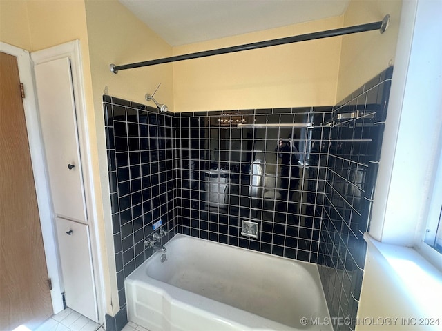 bathroom featuring tile patterned floors and tiled shower / bath combo