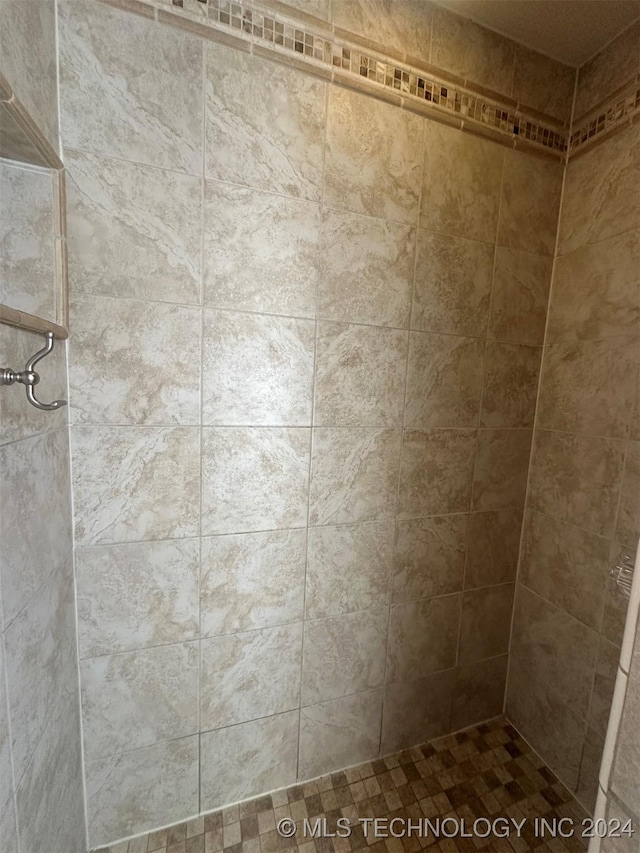 bathroom with a tile shower